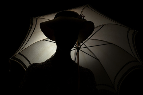 Silhouette woman with an umbrella. - Photo, Image