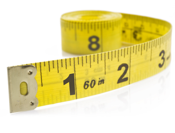 Yellow tape measure on rolled up on white background - Photo, Image