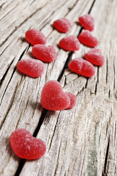 Red heart shaped jelly sweets on a rustic background - Photo, Image