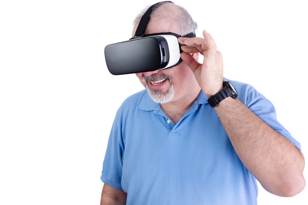 Man smiling at something in virtual headset - Photo, image