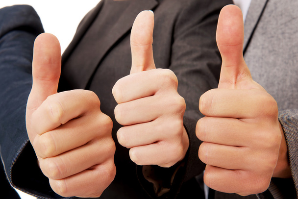 Three business people showing thumbs up - Foto, immagini