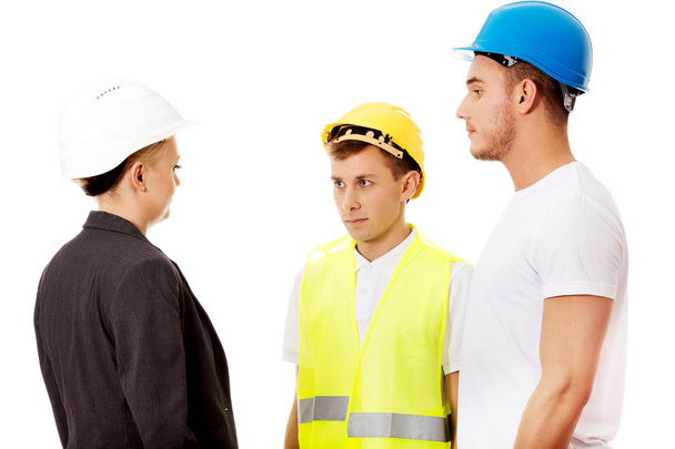 Female engineer talking with two builders - Photo, Image
