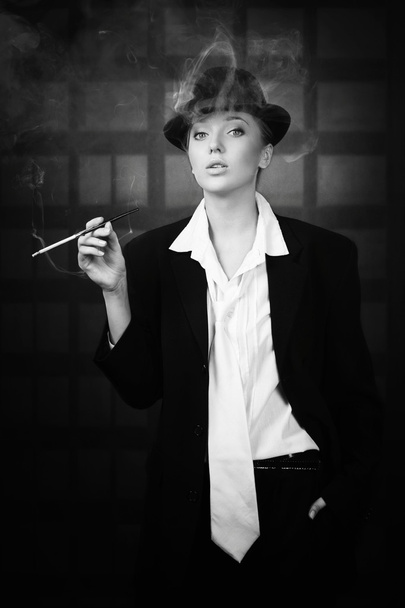 Attractive woman smoking on the night city street - 写真・画像
