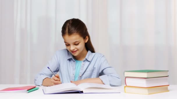 school girl writing math task to notepad - Video, Çekim