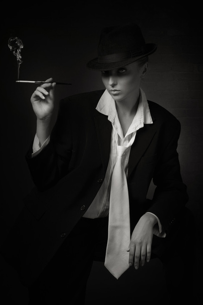 Woman smoking cigarette in mouthpiece - Foto, imagen
