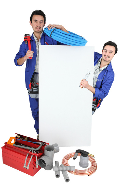 Plumber with a board left blank for your message - Foto, immagini