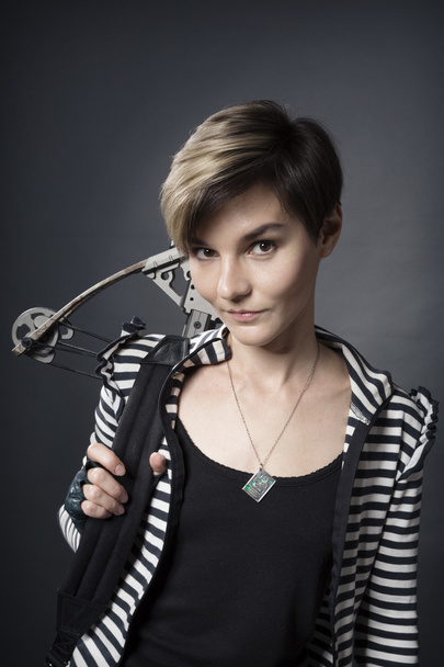 young woman with a crossbow - Фото, изображение