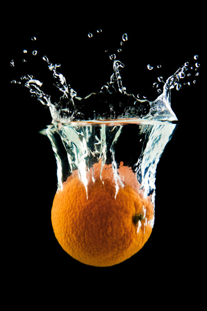 Orange falling in the water - Photo, image