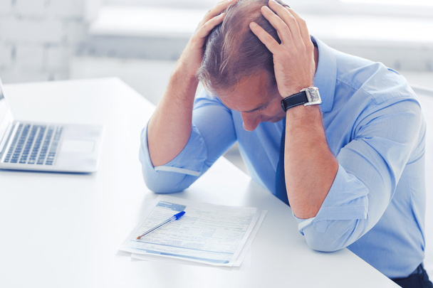 stressed businessman with papers at work - Photo, image