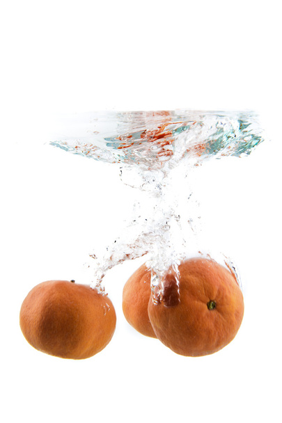 tangerine falling in the water - Foto, Imagen