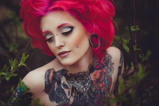 Portrait of tattooed girl with pink hair - Фото, изображение