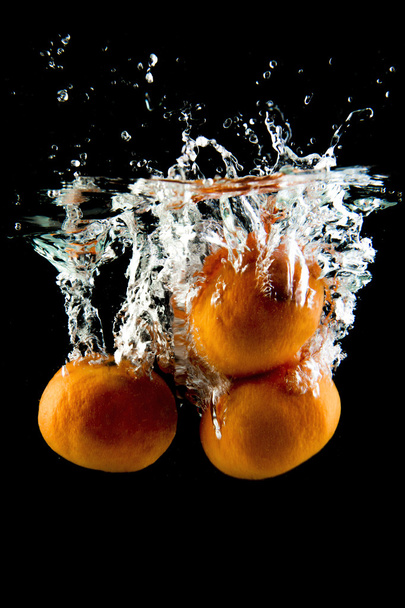 tangerine falling in the water - Foto, Bild