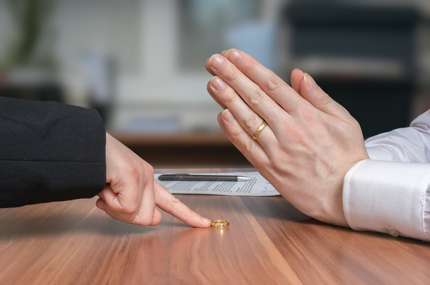 Divorce concept. Wife is returning ring to her disappointed husband who diagree and is begging for forgiveness. - Photo, Image