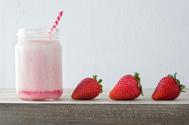 Delicious strawberry smoothie on a rustic wood - Photo, Image