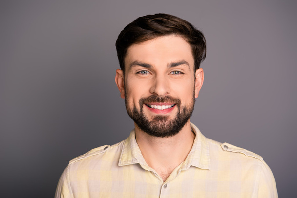 Portrait of attractive happy young man on gray background - Zdjęcie, obraz