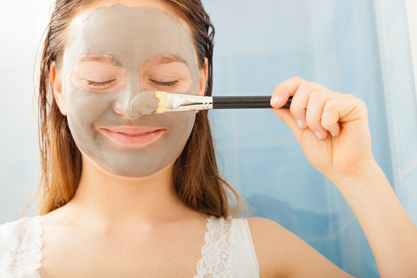 Woman applying mud facial mask - Foto, imagen