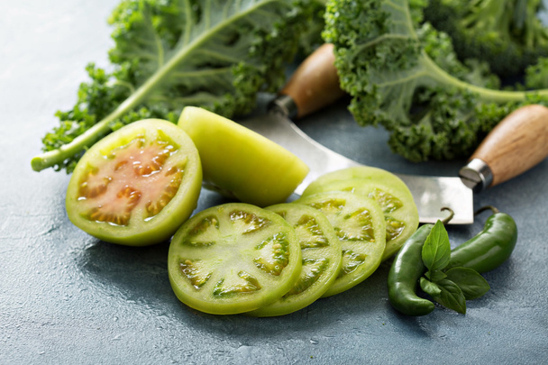 Fresh green tomato cut on the table - Foto, Imagen