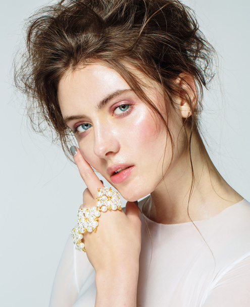 Portrait of young beautiful woman with natural beauty, nude makeup, bridal hairstyle and jewellery - Fotoğraf, Görsel