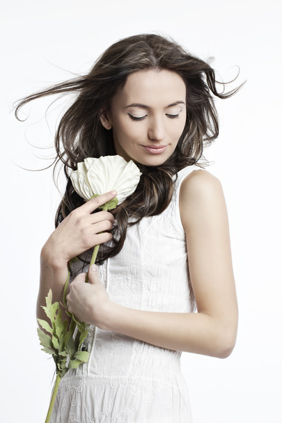 Portrait of a beautiful girl in white with a flower - Zdjęcie, obraz