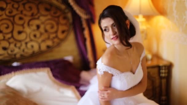 Incredibly beautiful bride wearing beautiful fashionable white wedding dress posing on a professional camera and smile . - Footage, Video