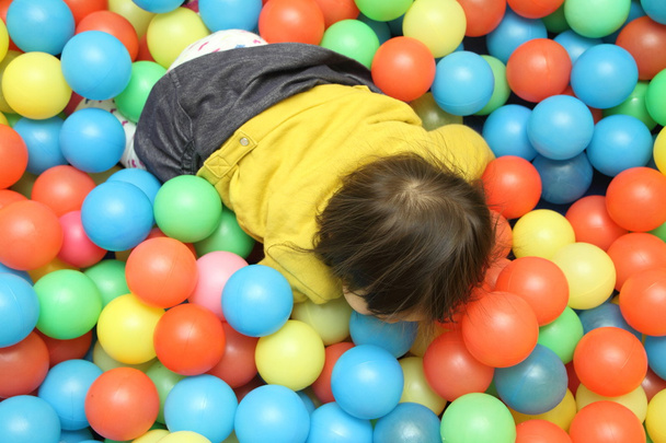 Japanese baby girl playing in ball pool (1 year old) - Photo, Image