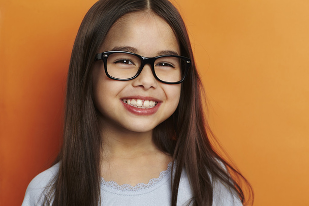 Smiling girl on orange - Фото, изображение