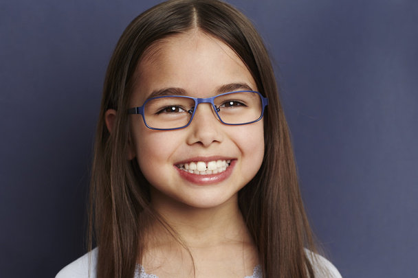 Smiling young girl in glasses - 写真・画像