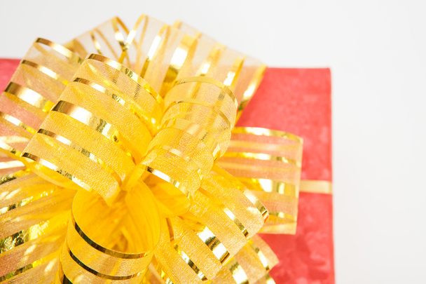 red gift box with gold ribbon and bow . - Foto, Bild