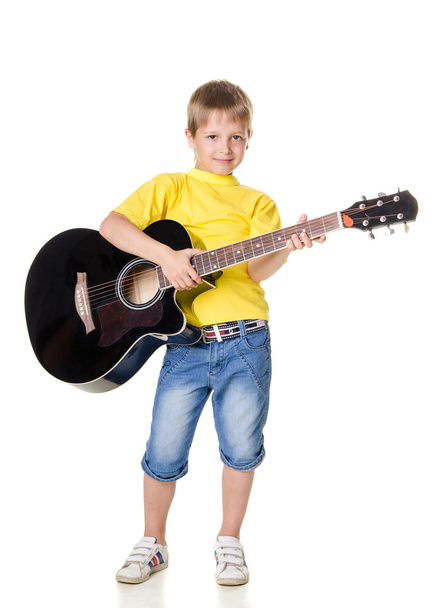 boy stands and plays on guitar isolated on white background - Foto, Imagem