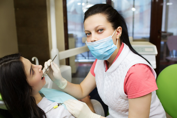 dentist cleaning teeth of patient - Photo, image