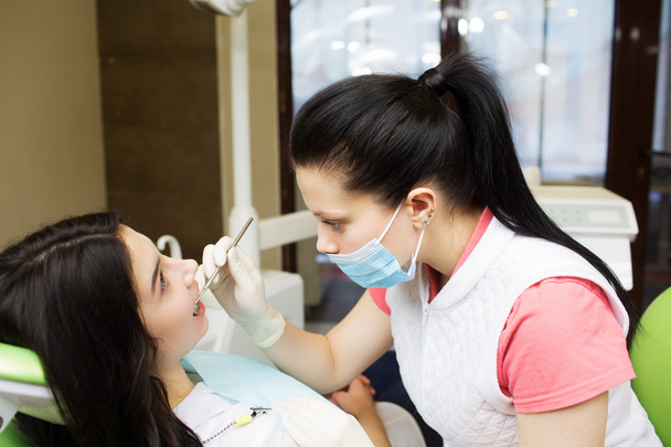 dentist cleaning teeth of patient - Photo, Image
