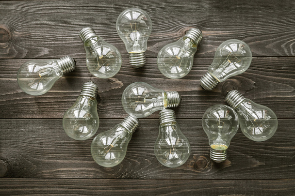 incandescent lamps on the wooden rustic background - Photo, image
