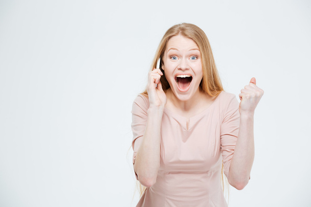 Excited woman talking on the phone - Photo, image