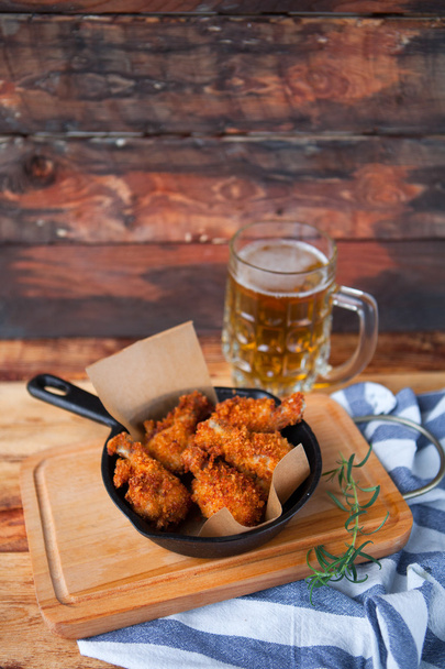 A plate of fresh, hot, crispy fried chicken with red sause on a  - Fotografie, Obrázek