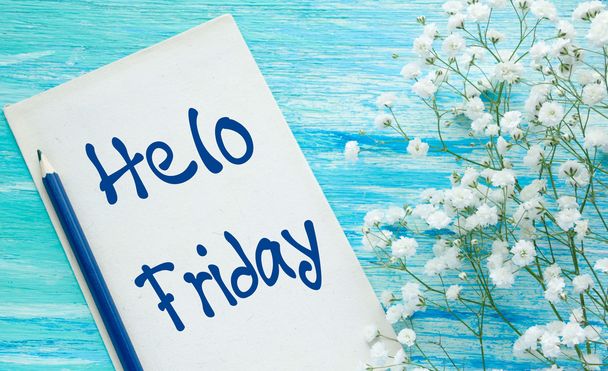 Hello Friday inspirational quotes lettering for postcards, business ideas, announcements, write a note with beautiful handwriting of a female hand notebook. wooden background - Photo, Image