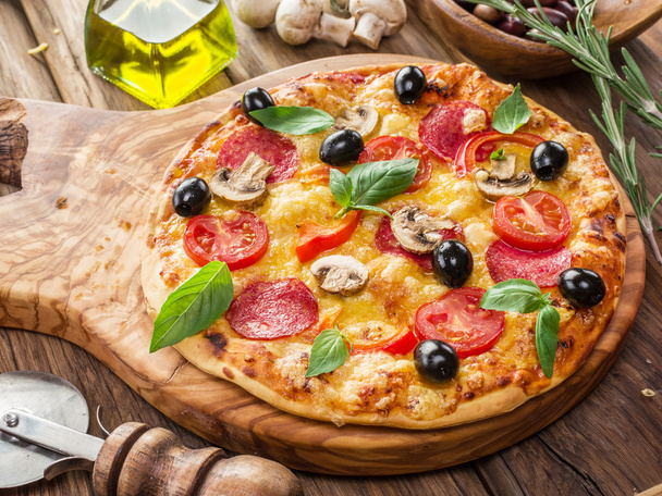 Pizza with mushrooms, salami and tomatoes. - 写真・画像