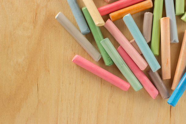 Group colored pastel chalks on a wooden background - Photo, Image