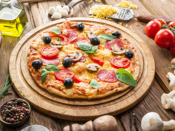 Pizza with mushrooms, salami and tomatoes. - Фото, изображение
