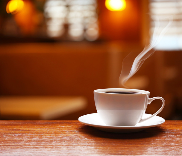 Cup of coffee on table on blured cafe background - Foto, Imagen