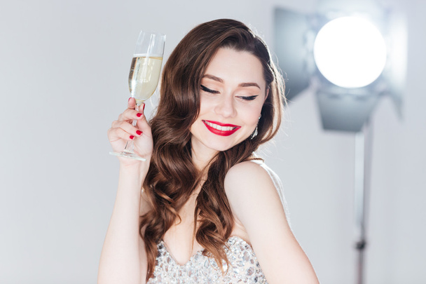 Woman holding glass of champagne - Zdjęcie, obraz