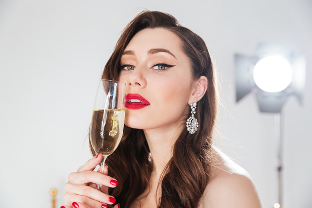 Woman holding glass with champagne  - Valokuva, kuva