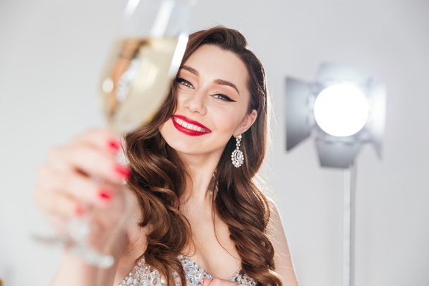 Woman holding glass of champagne  - 写真・画像