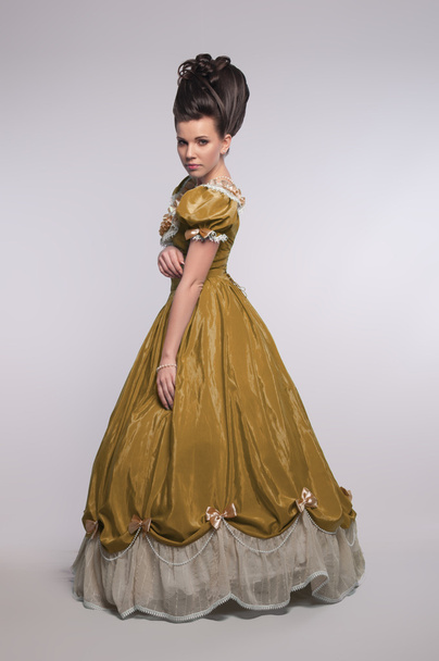 Old fashioned girl in yellow dress - Фото, изображение