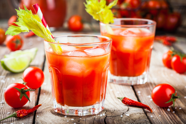 tomato juice with celery and ice in glasses  - Photo, Image