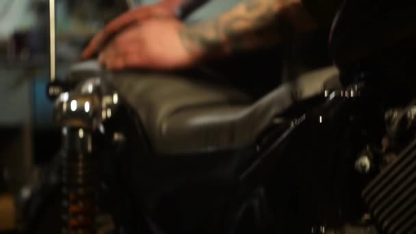 Auto mechanic assembles custom motorcycle in his workshop. - Video