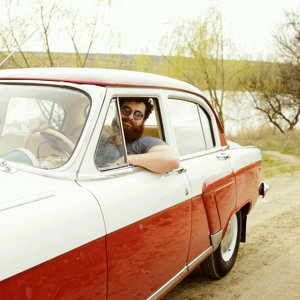Bearded man behind the wheel of a retro car - Photo, Image