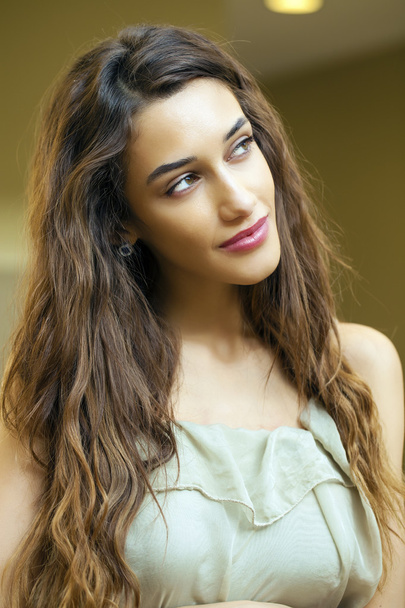 Portrait close up of young beautiful brunette woman in beige dre - 写真・画像