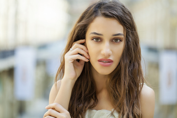 Portrait close up of young beautiful brunette woman in beige dre - Photo, image