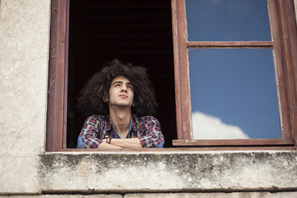 Portrait of young man looking at window - Foto, Bild