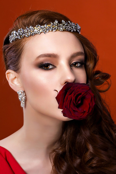 sensual woman with red rose in mouth - Photo, image